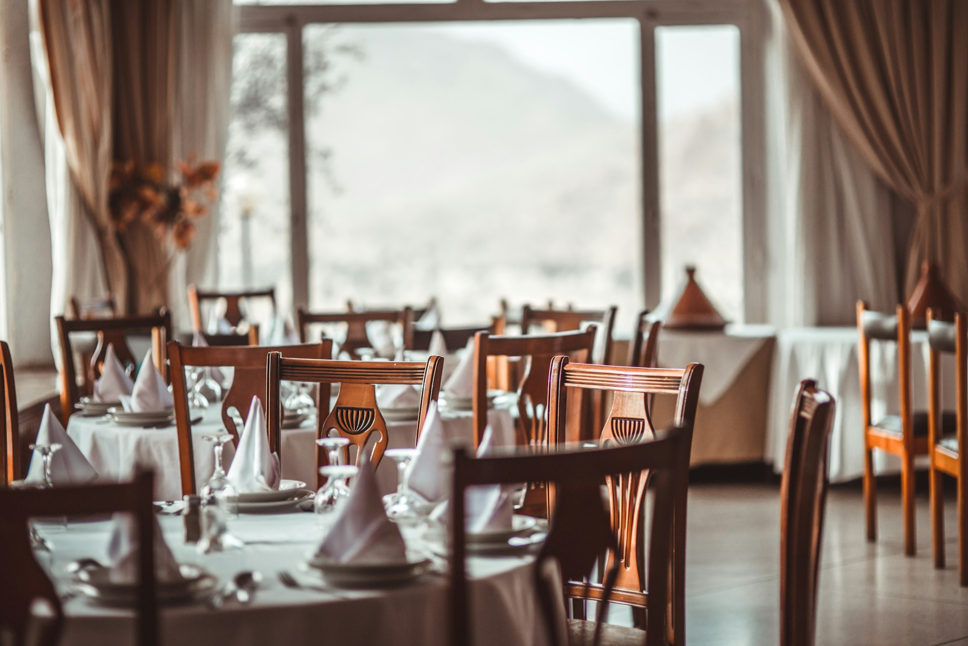 elegant modern table setting in a dimly lit restaurant, high end dining
